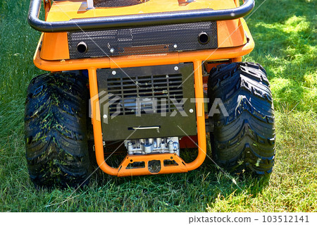 Professional grass cutting on lawns with a mini tractor lawn mower.  103512141