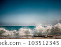 Stone beach on the sea with lots of foam and splashes 103512345