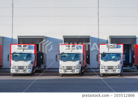 Freight trucks stand by the door. 103512866
