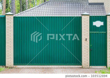 Metal fence and door of the luxury house. 103512894