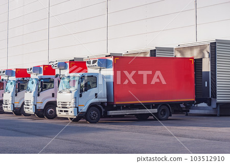 Freight trucks stand by the door. 103512910