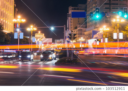 Car lights on the central city streets at evening time Car lights on the central city streets at evening time 103512911