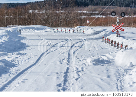 Countryside road crosses railroad track at winter. 103513173