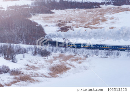 Retro steam train moves at winter morning. 103513223
