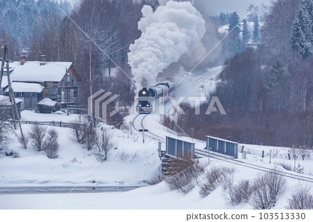 Retro steam train moves at winter day. 103513330