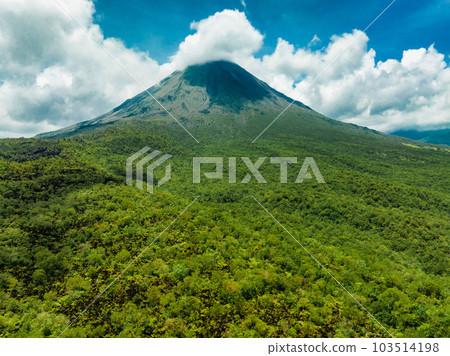 Amazing view of beautiful Arenal volcano in Costa Rica. Panorama of volcano Arenal reflected on wonderful picturesque lake, La Fortuna, Costa Rica. Central America. Amazing view of beautiful Arenal volcano in Costa Rica. Panorama of volcano Arenal reflected on wonderful picturesque lake, La Fortuna, Costa Rica. Central America. 103514198