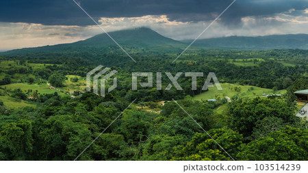 Amazing view of beautiful Arenal volcano in Costa Rica. Panorama of volcano Arenal reflected on wonderful picturesque lake, La Fortuna, Costa Rica. Central America. Amazing view of beautiful Arenal volcano in Costa Rica. Panorama of volcano Arenal reflected on wonderful picturesque lake, La Fortuna, Costa Rica. Central America. 103514239