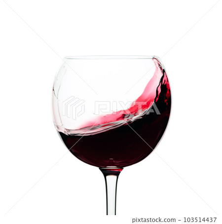 Splash of red wine in a glass isolated on  white. 103514437
