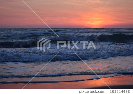 A beautiful sunset on the beach in the turbulent ocean A beautiful sunset on the beach in the turbulent ocean 103514488