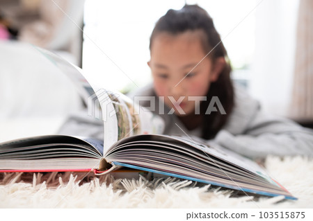 A girl reading a book A girl reading a book 103515875