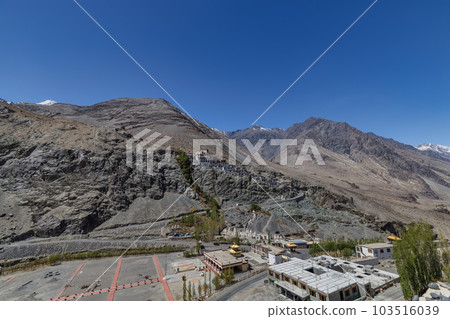 Big Sitting Buddha Statue at Diskit Monastery with Himalaya Range in the back - Nubra Valley, Ladakh, India. 103516039