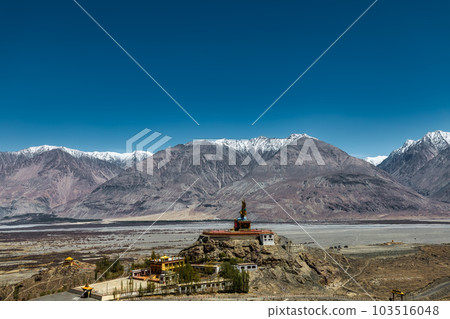 Big Sitting Buddha Statue at Diskit Monastery with Himalaya Range in the back - Nubra Valley, Ladakh, India. Big Sitting Buddha Statue at Diskit Monastery with Himalaya Range in the back - Nubra Valley, Ladakh, India. 103516048