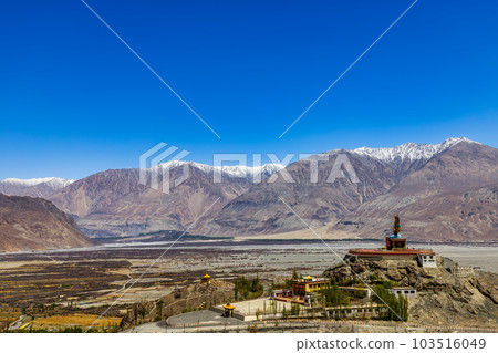 Big Sitting Buddha Statue at Diskit Monastery with Himalaya Range in the back - Nubra Valley, Ladakh, India. Big Sitting Buddha Statue at Diskit Monastery with Himalaya Range in the back - Nubra Valley, Ladakh, India. 103516049