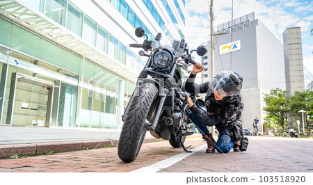 Engine trouble Female rider touring Yokohama on a large cruiser bike Engine trouble Engine trouble Female rider touring Yokohama on a large cruiser bike Engine trouble 103518920