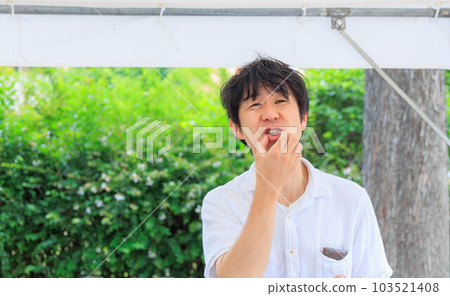 A man with a grumpy face while touching a smartphone A man with a grumpy face while touching a smartphone 103521408