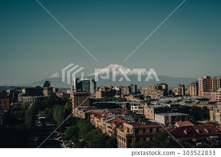 Cityscape with mountain view in a day time concept photo. Yerevan, capital of Armenia 103522833