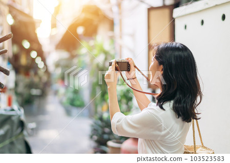 Happy youth asian woman person with camera travels street city trip on leisure weekend. Young hipster girl female tourist sightseeing summer urban Bangkok destination lifestyle concept. Happy youth asian woman person with camera travels street city trip on leisure weekend. Young hipster girl female tourist sightseeing summer urban Bangkok destination lifestyle concept. 103523583