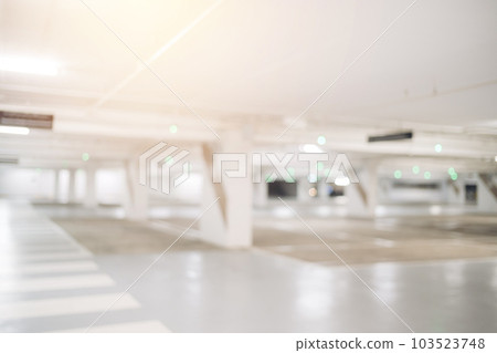 Blur image of empty car park in basement of garage shopping mall. Defocused interior background concept 103523748