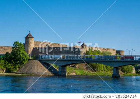 Ivangorod Fortress on the banks of the Narva River on a sunny May day 103524714