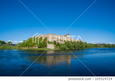 Ivangorod Fortress on the banks of the Narva River on a sunny May day 103524724