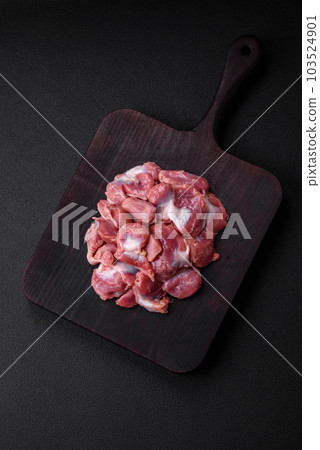 Raw chicken or turkey gizzards with salt, spices and herbs 103524901