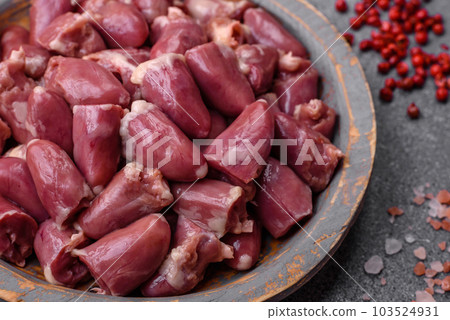 Raw chicken or turkey hearts with salt, spices and herbs 103524931
