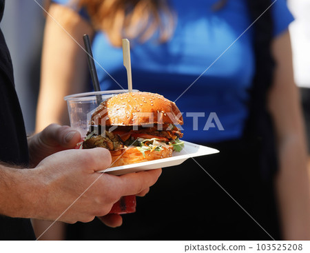 Buying hamburgers at street food market 103525208