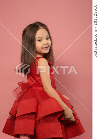cute little girl in red dress happy closeup portrait on pink background 103525910