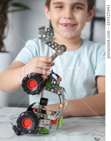 little preteen boy play with steel mechanical constructor set close up photo 103525941