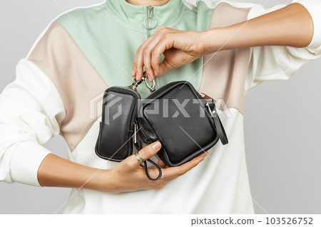 Female Hands Holding Small Leather Coin Purses 103526752