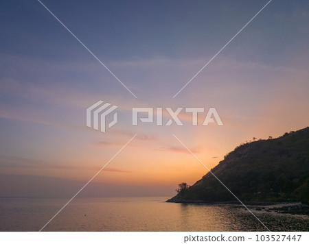 aerial view the sun going down in colorful sky impact on ocean surface The beauty of the cliff fits perfectly with the charming nature in beautiful sunset. cloud scape background aerial view the sun going down in colorful sky impact on ocean surface The beauty of the cliff fits perfectly with the charming nature in beautiful sunset. cloud scape background 103527447