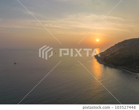 aerial view the sun going down in colorful sky impact on ocean surface The beauty of the cliff fits perfectly with the charming nature in beautiful sunset. cloud scape background aerial view the sun going down in colorful sky impact on ocean surface The beauty of the cliff fits perfectly with the charming nature in beautiful sunset. cloud scape background 103527448