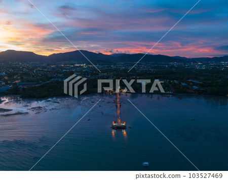 aerial photography cloud above Palai pier at beautiful sunset..Palai pier is next to Chalong pier..fishing boats parking on the beach..colorful cloud above the mountain range background.. aerial photography cloud above Palai pier at beautiful sunset..Palai pier is next to Chalong pier..fishing boats parking on the beach..colorful cloud above the mountain range background.. 103527469