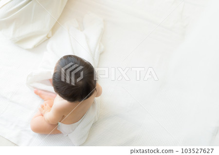 A baby wrapped in a bath towel A baby wrapped in a bath towel 103527627