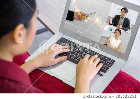 Back view of businesswoman typing on laptop computer keyboard while videoconference on-line meeting with the investment advisor. Work from home concept Back view of businesswoman typing on laptop computer keyboard while videoconference on-line meeting with the investment advisor. Work from home concept 103528251