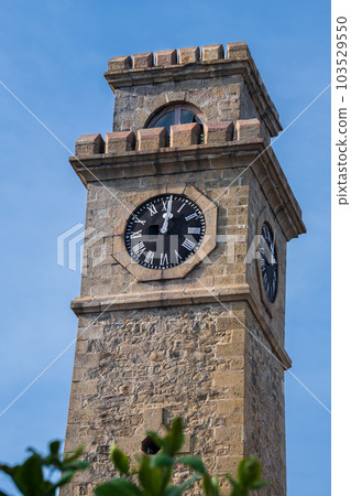 Galle Fort clock tower upper part close up shot against the blue skies. Galle Fort clock tower upper part close up shot against the blue skies. 103529550