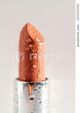Moisturizing lipstick with water drops on it. Moisturizing lipstick with water drops on it. 103529763