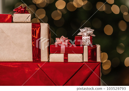 Gifts on the background of a Christmas tree with a bokeh. Gifts on the background of a Christmas tree with a bokeh. 103529793