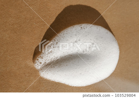 Texture of white foam on a beige background. 103529804