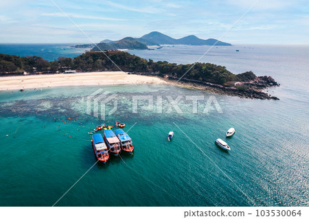 Scenery of tropical sea beach with boat anchored and tourist with leisure activity in summer on sunny day at Koh Larn 103530064