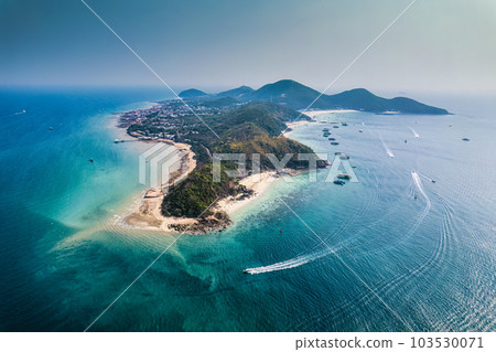 Beautiful tropical sea beach with boat anchored and tourist playing water sports in summer on sunny day at Koh Larn Beautiful tropical sea beach with boat anchored and tourist playing water sports in summer on sunny day at Koh Larn 103530071