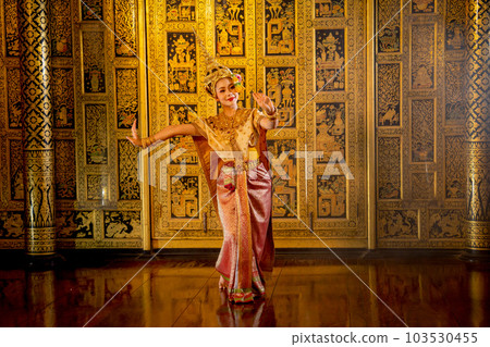 Wide shot of beautiful Asian woman wear Thai ancient traditional dress action of dancing Wide shot of beautiful Asian woman wear Thai ancient traditional dress action of dancing 103530455