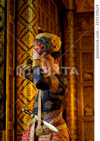Vertical image of Asian man with traditional cloth relate to Khon or Thai classic masked Vertical image of Asian man with traditional cloth relate to Khon or Thai classic masked 103530624