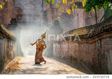 Asian beautiful woman with traditional dress dance with different actions on the way to building Asian beautiful woman with traditional dress dance with different actions on the way to building 103530716