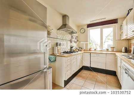 a kitchen with an oven, sink and dishwasher on the floor in front of the refrigerator freezer 103530752