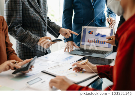 Businessman and team analyzing financial statement Finance task. with smart phone and laptop and  tablet. Wealth management concept. 103531145