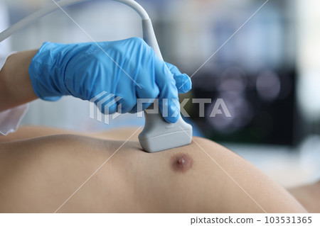 Doctor conducts ultrasound examination of patient heart 103531365