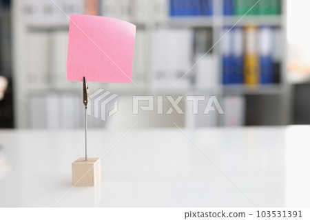 Blank pink sticky note on desktop closeup Blank pink sticky note on desktop closeup 103531391