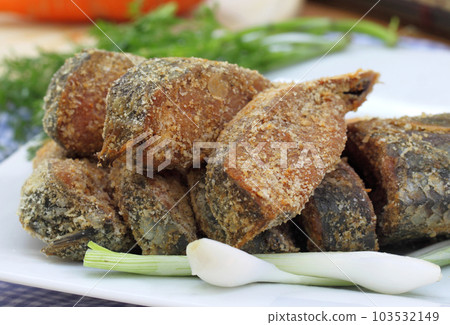 Closeup of uncooked preserved Ilish fish with vegetables 103532149