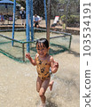Girl playing in a park fountain 103534191